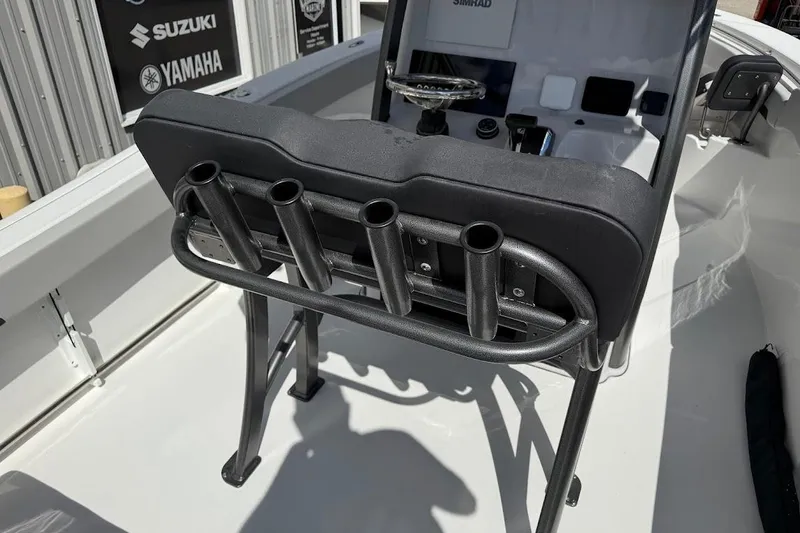 Slide: The Image of 2026 Sea Pro 242 Center Console boat interior with rod holders and control panel. - 24