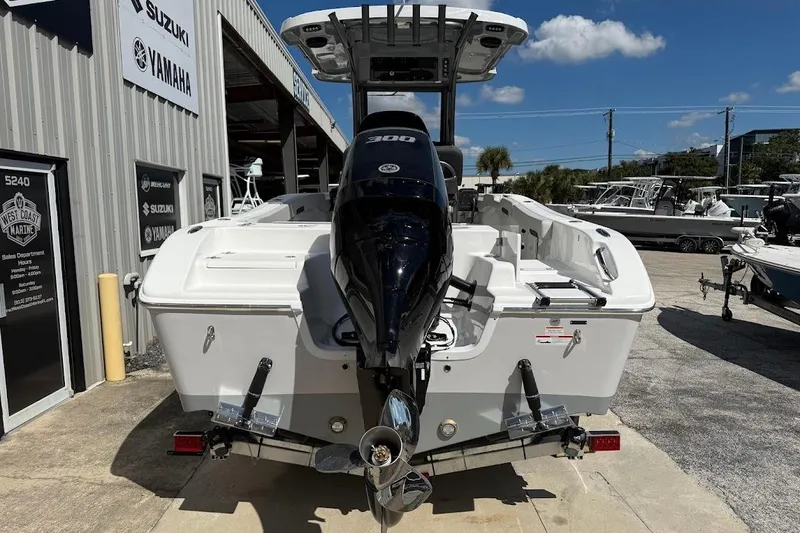 Slide: The Image of 2026 Sea Pro 242 Center Console boat with powerful outboard motor, docked at marina. - 6
