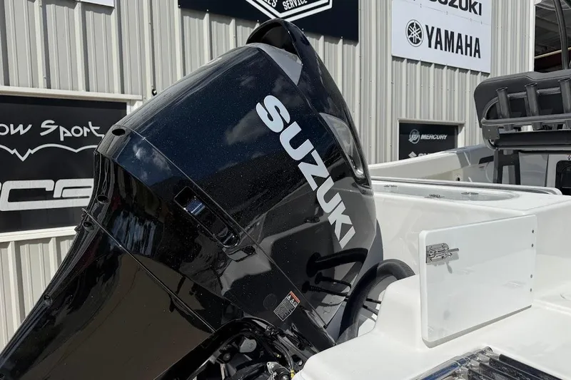 Slide: The Image of 2026 Sea Pro 242 Center Console with Suzuki outboard motor at dealership. - 9