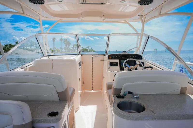 Slide: The Image of 2014 Grady-White Freedom 307 boat interior with helm, seating, and ocean view. - 10