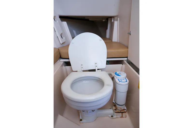 Slide: The Image of 2014 Grady-White Freedom 307 boat interior with toilet and seating area. - 15