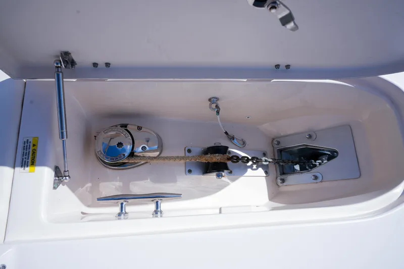 Slide: The Image of Anchor locker of 2014 Grady-White Freedom 307 boat, featuring chain and windlass system. - 16