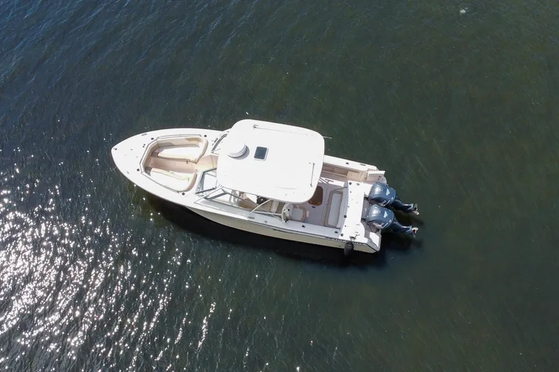 Slide: The Image of 2014 Grady-White Freedom 307 boat on calm water, aerial view. - 2