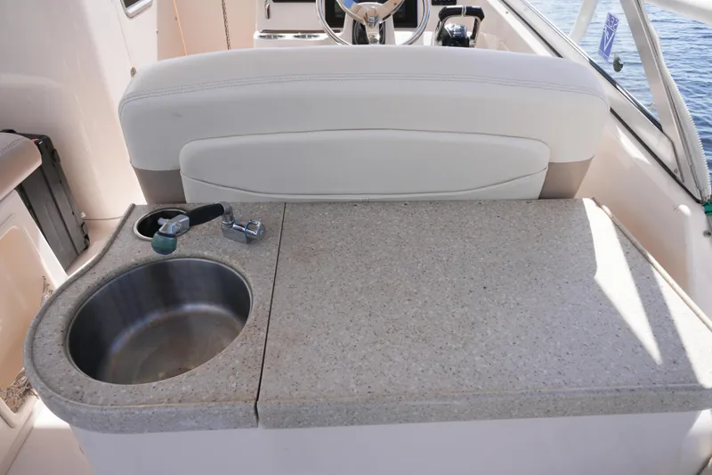 Slide: The Image of 2014 Grady-White Freedom 307 boat interior with sink and countertop. - 23