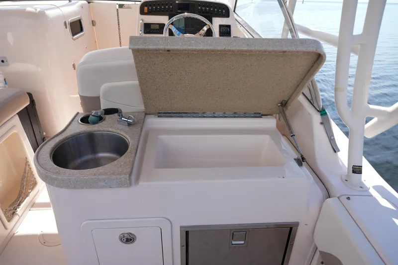Slide: The Image of 2014 Grady-White Freedom 307 boat interior with sink and storage compartment. - 30