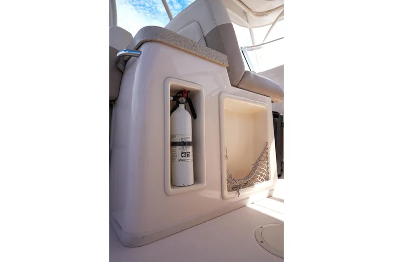 Slide: The Image of 2014 Grady-White Freedom 307 boat interior with fire extinguisher and storage compartment. - 35