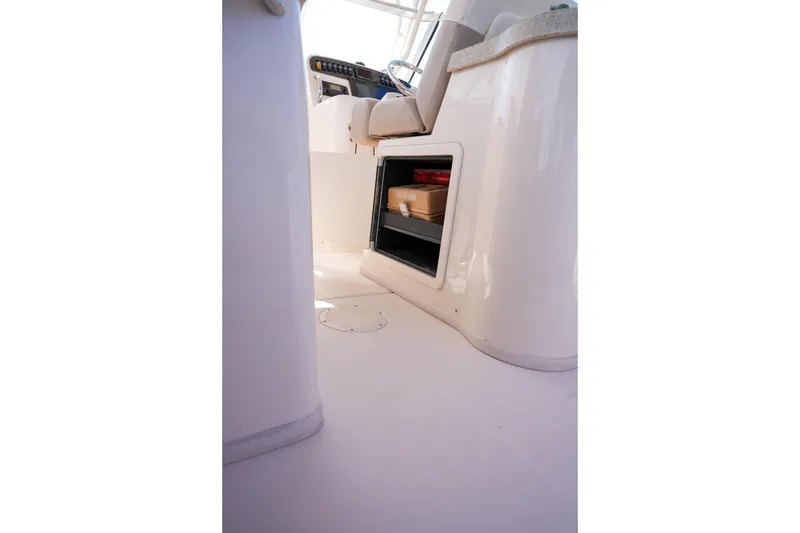 Slide: The Image of Interior view of 2014 Grady-White Freedom 307 boat, featuring storage compartment and seating area. - 36