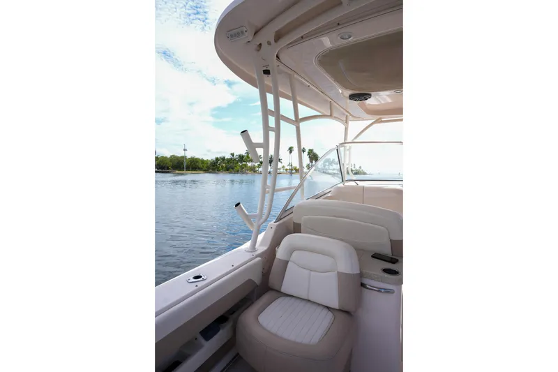 Slide: The Image of 2014 Grady-White Freedom 307 boat interior with seating, on calm water. - 38
