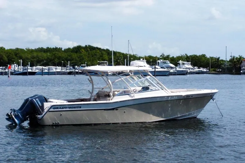 Slide: The Image of 2014 Grady-White Freedom 307 boat anchored on calm water near marina. - 4