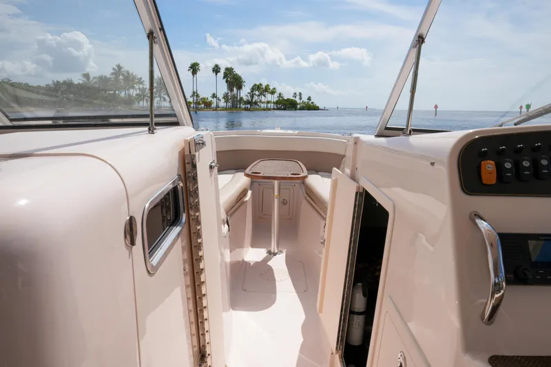 Slide: The Image of 2014 Grady-White Freedom 307 boat interior with ocean view and palm trees. - 40