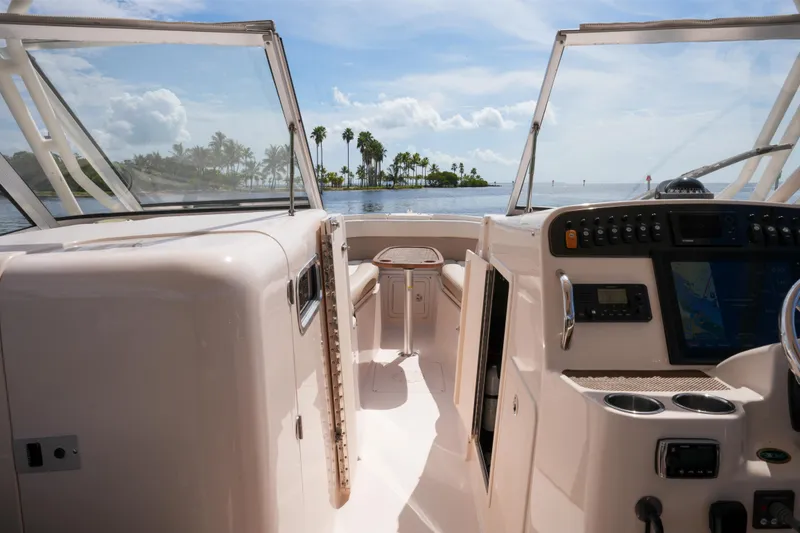 Slide: The Image of 2014 Grady-White Freedom 307 boat interior with ocean view and palm trees. - 41