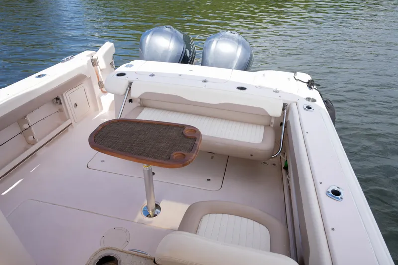 Slide: The Image of 2014 Grady-White Freedom 307 boat interior with seating and table on water. - 42