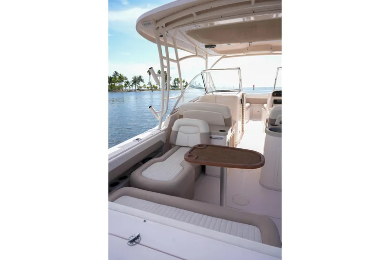 Slide: The Image of 2014 Grady-White Freedom 307 boat interior with seating and table, overlooking calm waters. - 44