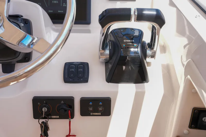 Slide: The Image of 2014 Grady-White Freedom 307 boat controls with Yamaha throttle and steering wheel. - 47