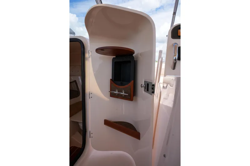Slide: The Image of Interior view of 2014 Grady-White Freedom 307 boat cabin with storage compartments. - 49