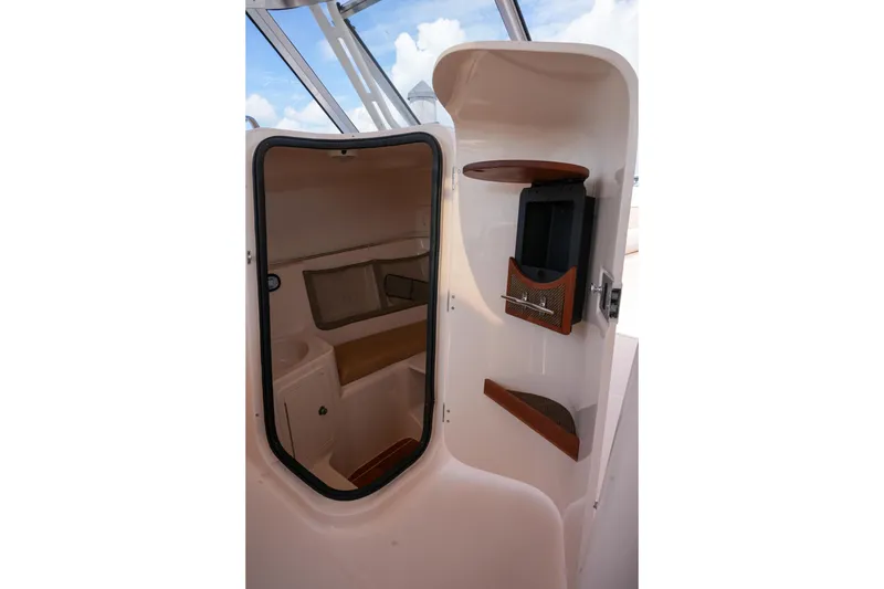Slide: The Image of 2014 Grady-White Freedom 307 cabin interior with storage and seating. - 50