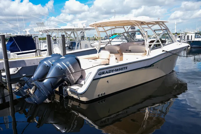 Slide: The Image of 2014 Grady-White Freedom 307 boat docked with twin Yamaha engines. - 55