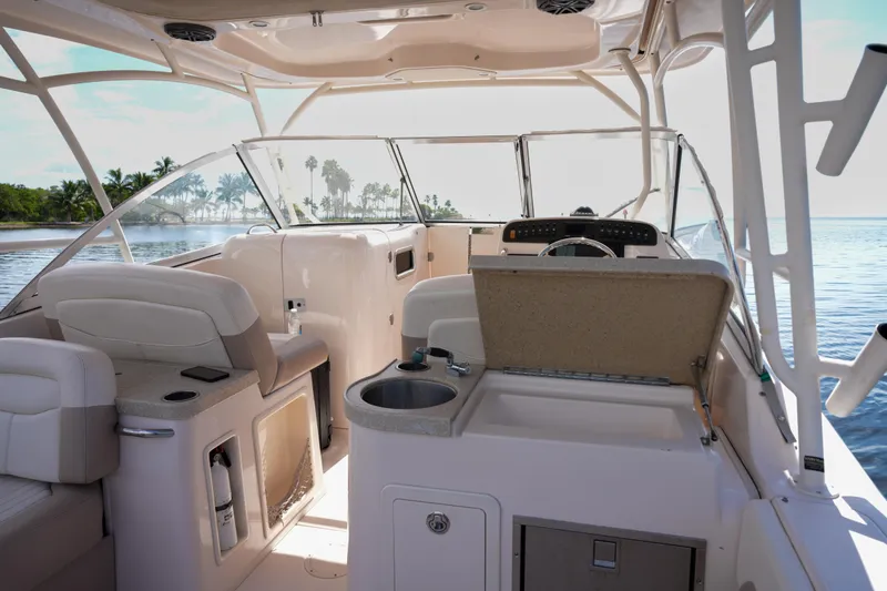 Slide: The Image of 2014 Grady-White Freedom 307 boat interior with seating and helm, overlooking serene water. - 9