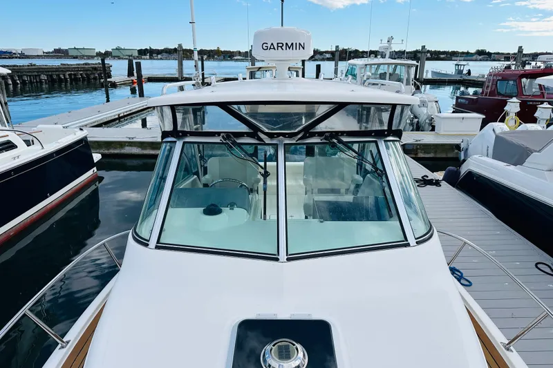 Slide: The Image of 2007 Pursuit OS 285 Offshore boat docked at marina with Garmin equipment. - 11