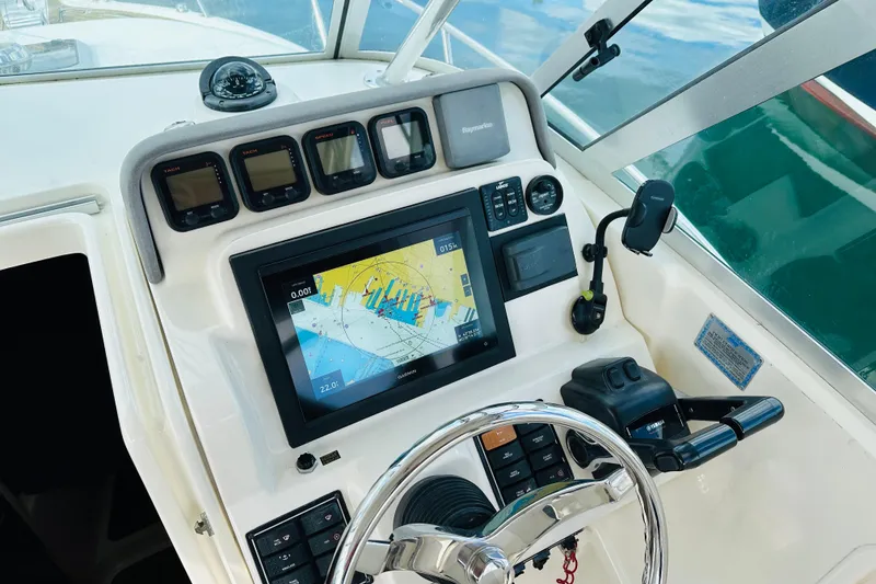 Slide: The Image of 2007 Pursuit OS 285 Offshore boat dashboard with navigation system and controls. - 19