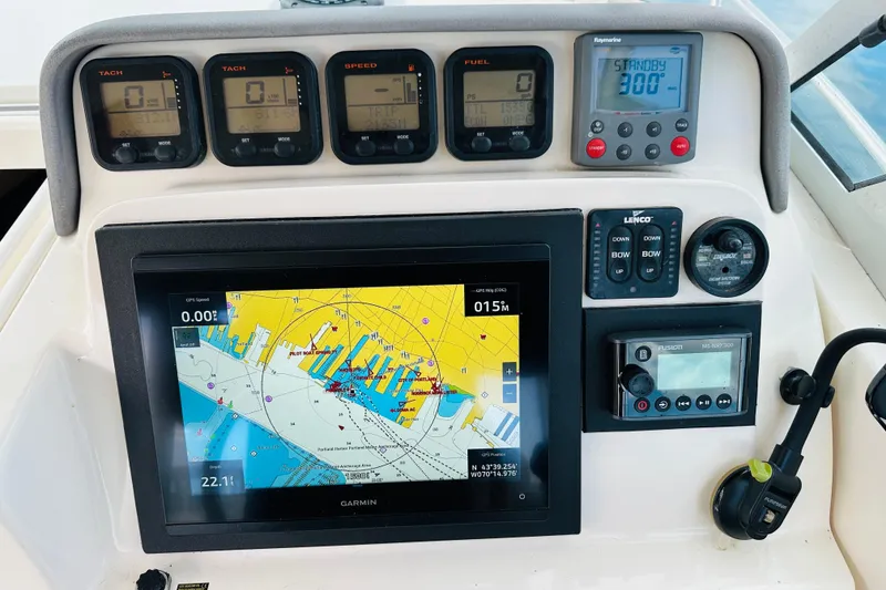 Slide: The Image of Dashboard of a 2007 Pursuit OS 285 Offshore boat with navigation and control instruments. - 20