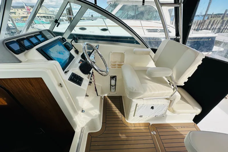 Slide: The Image of 2007 Pursuit OS 285 Offshore helm with modern controls and comfortable seating. - 23