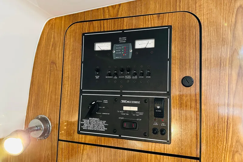 Slide: The Image of Control panel of a 2007 Pursuit OS 285 Offshore boat, featuring gauges and switches. - 32