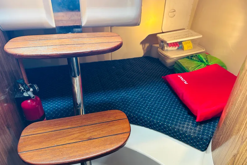 Slide: The Image of 2007 Pursuit OS 285 Offshore cabin interior with wooden steps and safety equipment. - 33