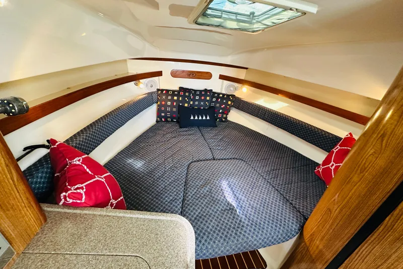 Slide: The Image of Cozy cabin interior of 2007 Pursuit OS 285 Offshore with patterned cushions and pillows. - 4