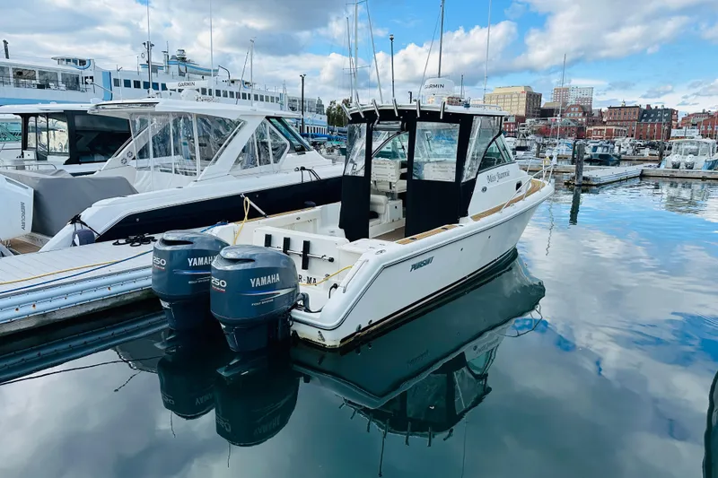 Slide: The Image of 2007 Pursuit OS 285 Offshore boat docked with twin Yamaha engines. - 5