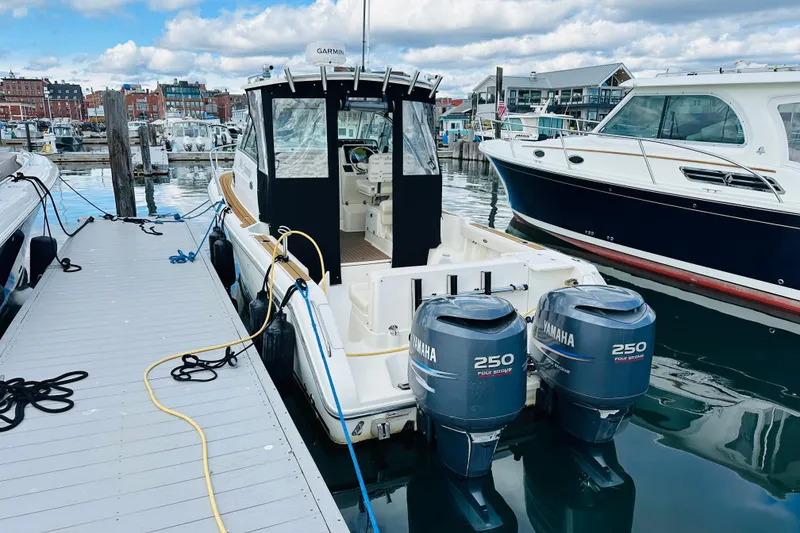 Slide: The Image of 2007 Pursuit OS 285 Offshore boat docked with twin Yamaha 250 engines. - 7