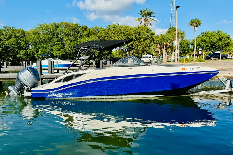 Slide: The Image of 2015 Starcraft Crossover 250 SCX OB boat docked on a sunny day. - 12