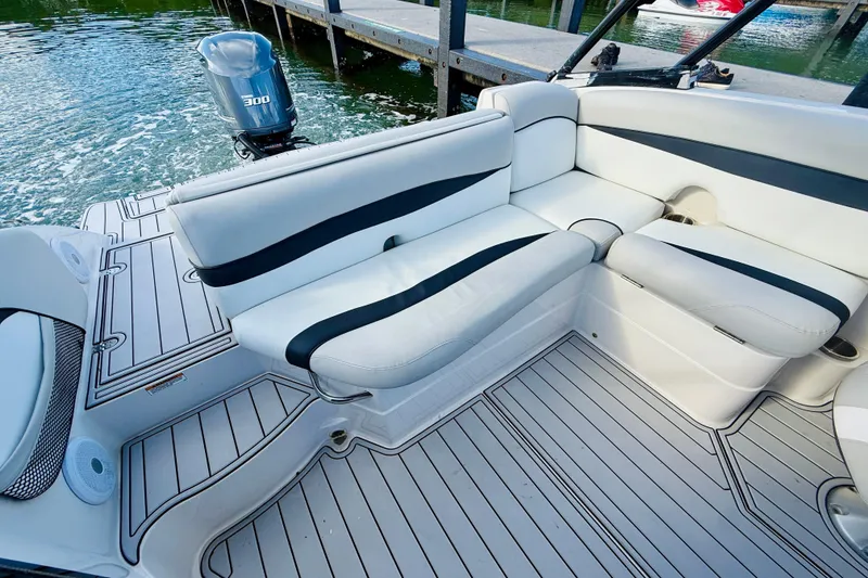 Slide: The Image of 2015 Starcraft Crossover 250 SCX OB boat interior with white seating and outboard motor. - 18