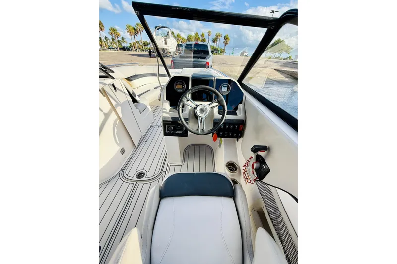 Slide: The Image of 2015 Starcraft Crossover 250 SCX OB boat interior with steering wheel and dashboard. - 19
