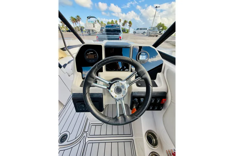 Slide: The Image of 2015 Starcraft Crossover 250 SCX OB boat dashboard with steering wheel and controls. - 20