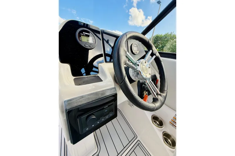 Slide: The Image of 2015 Starcraft Crossover 250 SCX OB boat steering wheel and dashboard, featuring modern controls. - 21