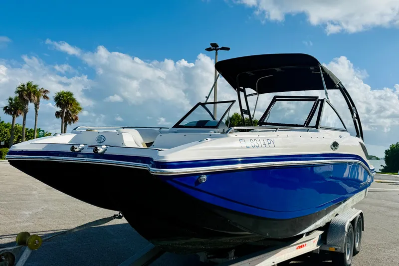 Slide: The Image of 2015 Starcraft Crossover 250 SCX OB boat on trailer under blue sky. - 3