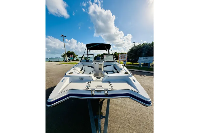 Slide: The Image of 2015 Starcraft Crossover 250 SCX OB boat on trailer under blue sky. - 7