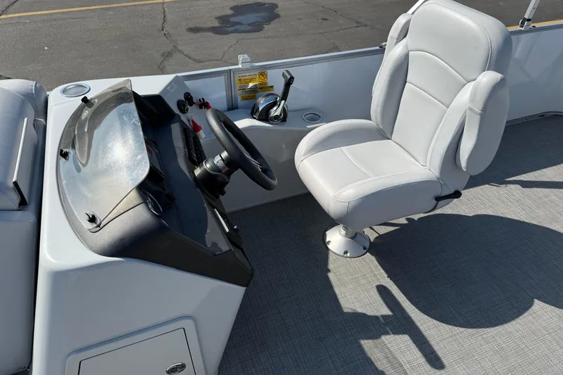 Slide: The Image of 2022 Bentley Pontoons 240 CRUISE helm with steering wheel and comfortable captain's chair. - 17