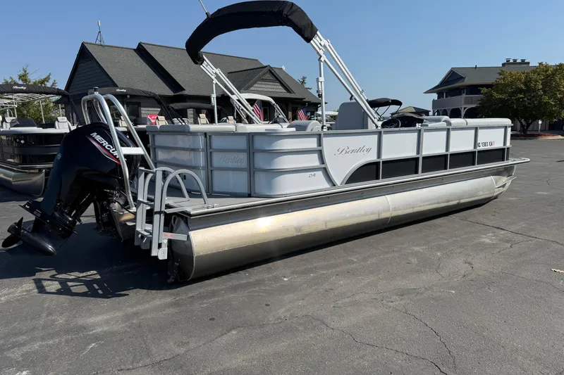 Slide: The Image of 2022 Bentley Pontoons 240 CRUISE pontoon boat with Mercury outboard motor, parked outdoors. - 4