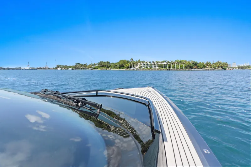 Slide: The Image of 2020 Princess R35 yacht cruising on clear blue waters near a lush island. - 13