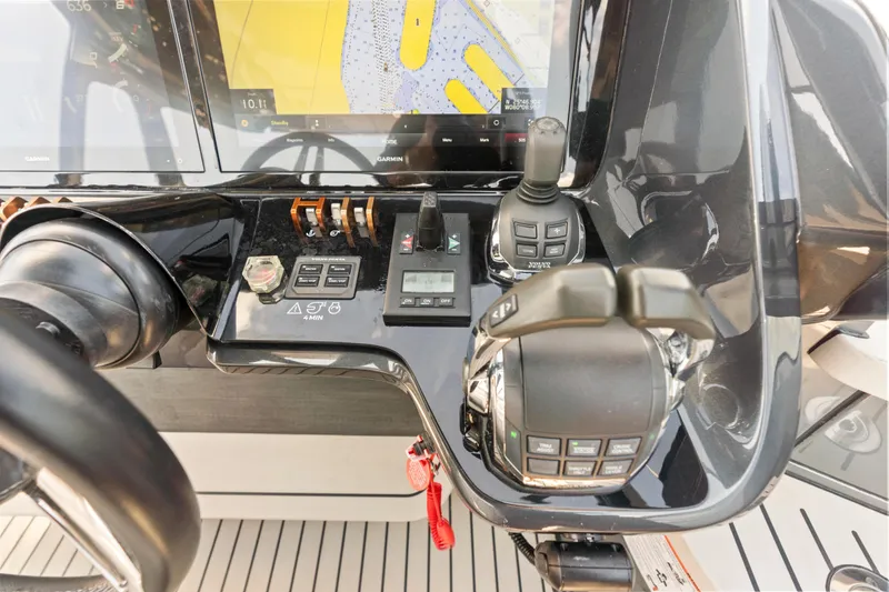 Slide: The Image of Control panel of a 2020 Princess R35 yacht with navigation display and joystick controls. - 17