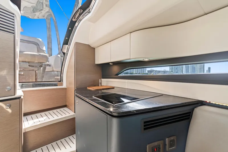 Slide: The Image of Interior of 2020 Princess R35 yacht with modern kitchen and cityscape view. - 24