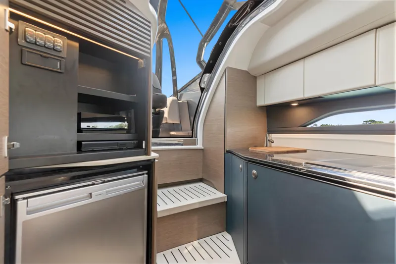 Slide: The Image of Modern kitchen interior of 2020 Princess R35 yacht, featuring sleek cabinetry and appliances. - 25