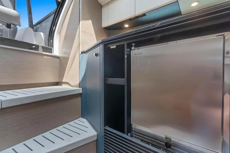 Slide: The Image of Modern yacht interior with stainless steel fridge, wooden steps, and sleek cabinetry in Princess R35, 2020. - 29