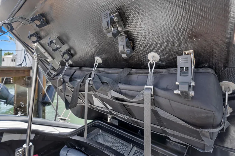 Slide: The Image of Storage compartment of a 2020 Princess R35 boat with secure straps and clips. - 32