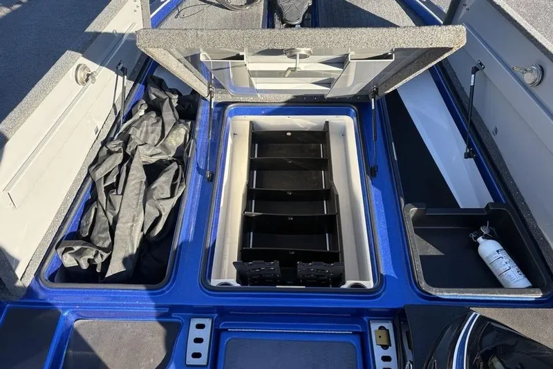 Slide: The Image of 2021 Caymas CX20 boat storage compartments with open lids and visible fire extinguisher. - 13