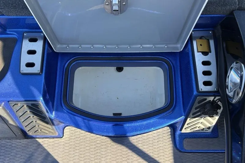 Slide: The Image of 2021 Caymas CX20 boat storage compartment with open lid and blue interior. - 15