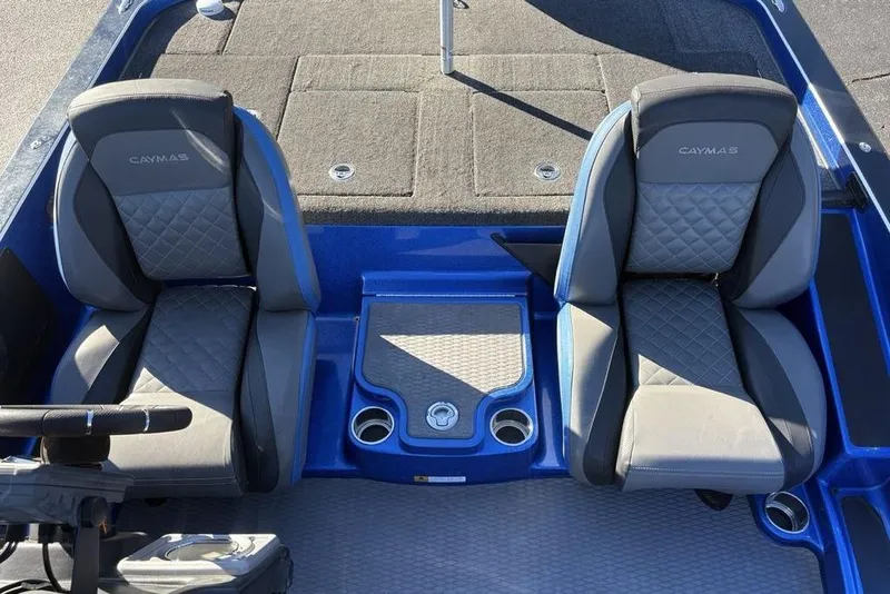 Slide: The Image of 2021 Caymas CX20 boat interior with two cushioned seats and cup holders. - 17