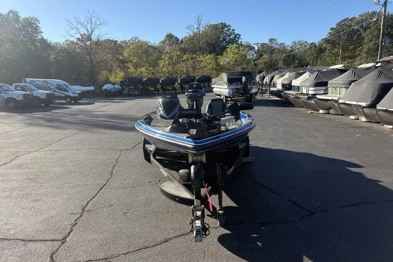 Slide: The Image of 2021 Caymas CX20 boat parked in a marina lot with covered boats. - 2